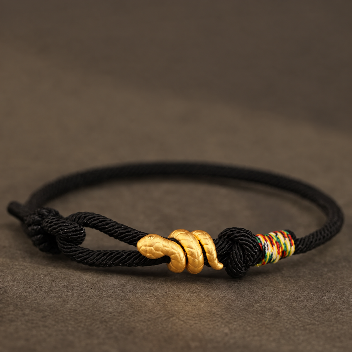 Snake motif bracelet with red, bright red, or black braided cord